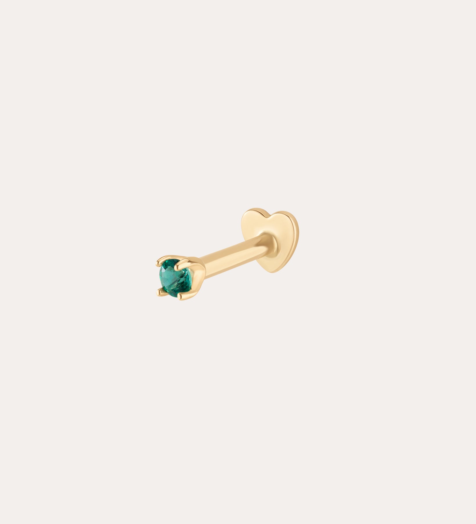 The 14K Solid Yellow Gold Green Emerald Flat Back Stud - 1.5mm features a small green emerald in a four-prong setting and heart-shaped back, shown on a white background. The color is 14K yellow gold with green emerald.