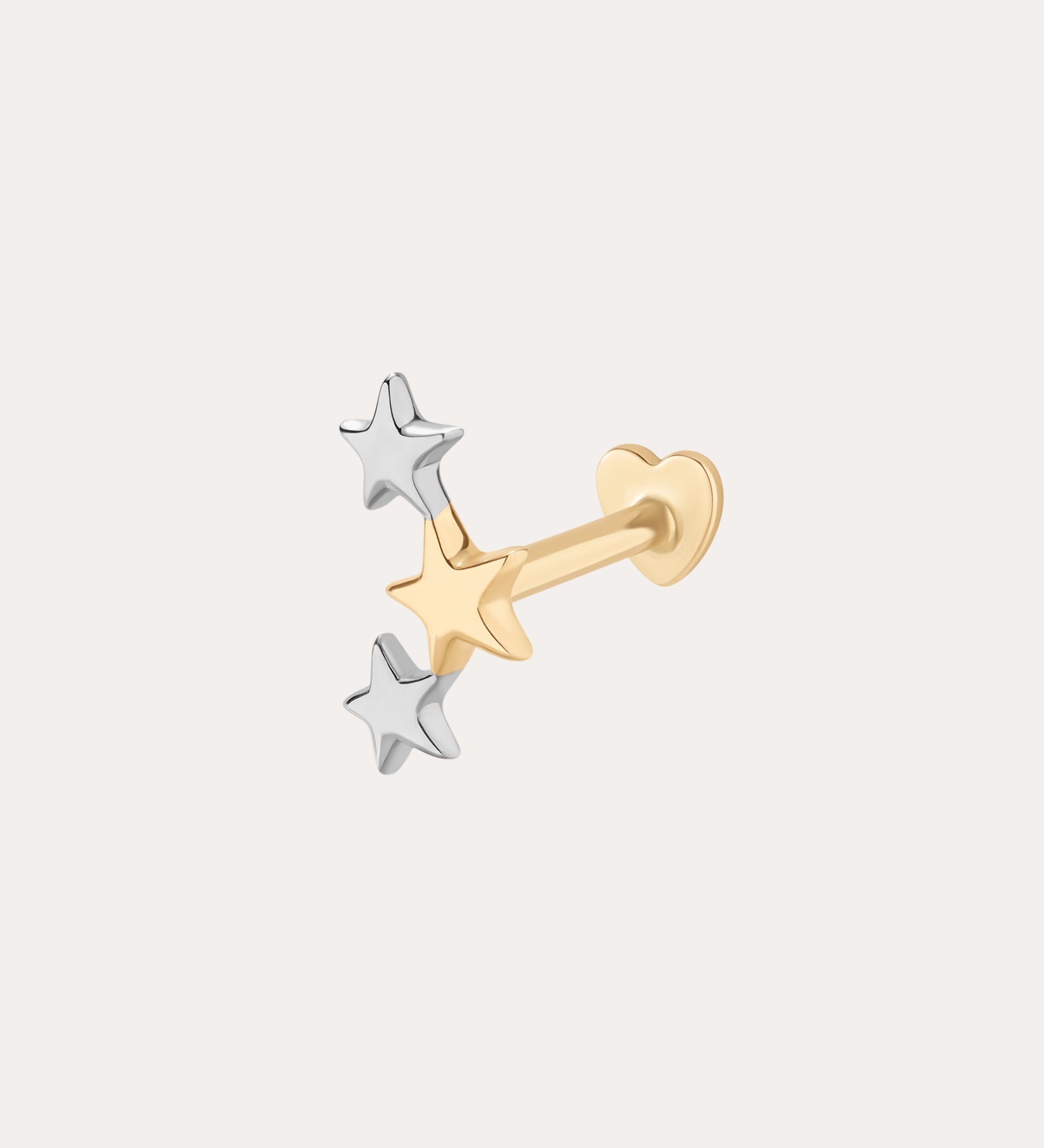 The 14K Solid Mixed Gold Star Cluster Flat Back Stud features three small stars—one gold, two silver—arranged in a cluster at the front. Its heart-shaped backing contrasts against a plain, light background. Color: Mixed Gold.