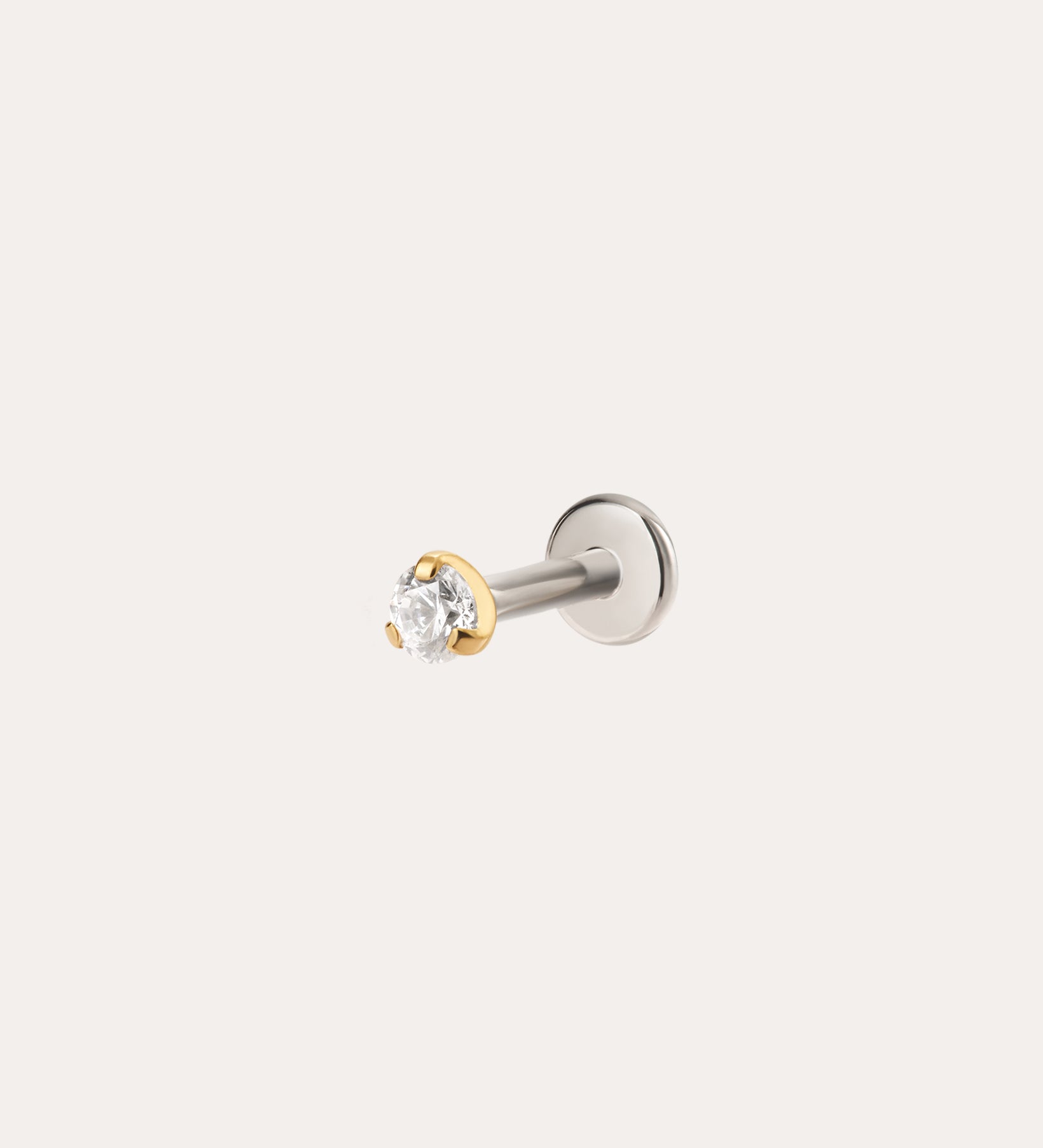 The 2.5mm Martini Set Threadless Flat Back Titanium Cartilage Stud in Yellow Gold PVD features a clear round gemstone and is displayed against a plain light background.