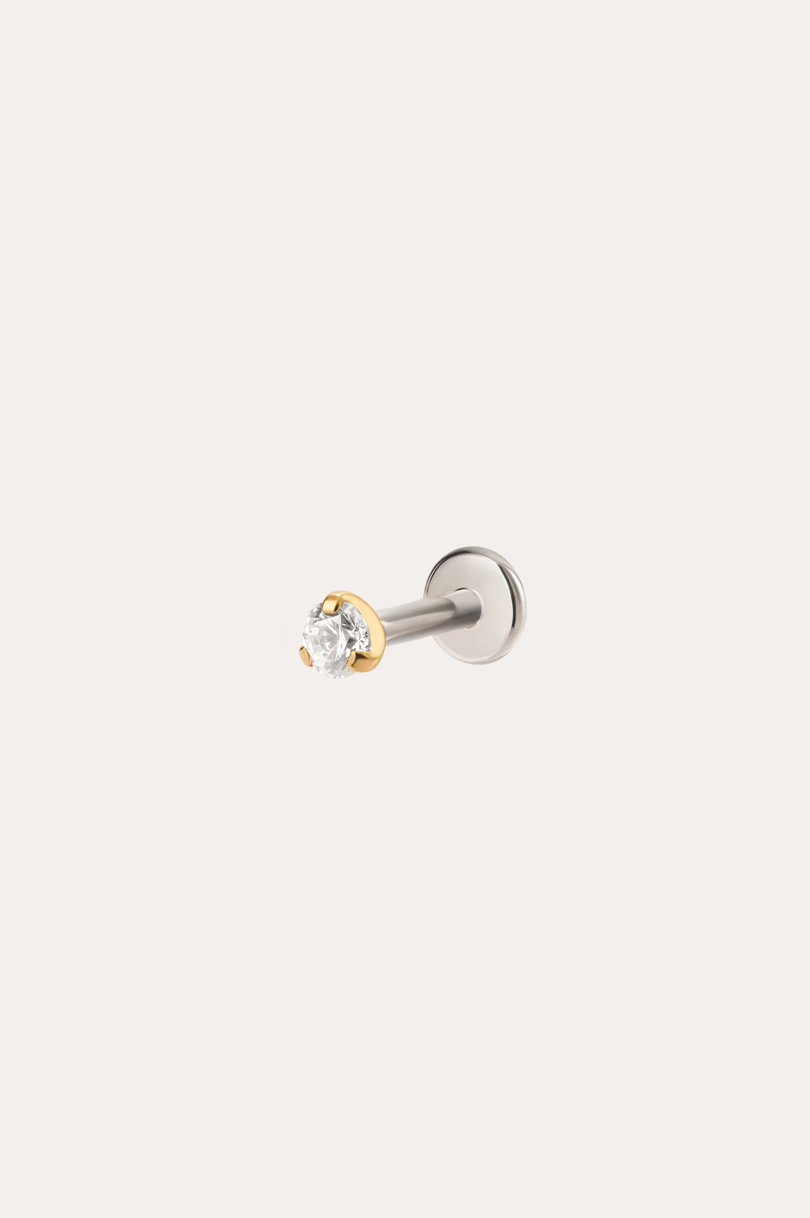 The 2.5mm Martini Set Threadless Flat Back Titanium Cartilage Stud in Yellow Gold PVD features a clear round gemstone and is displayed against a plain light background.