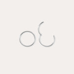 Two 14K Solid White Gold 20G Mini Clicker hoops are displayed on a plain white background—one closed, one slightly open—highlighting their simple, elegant circular design suitable for use as a nose ring or subtle ear accessory.