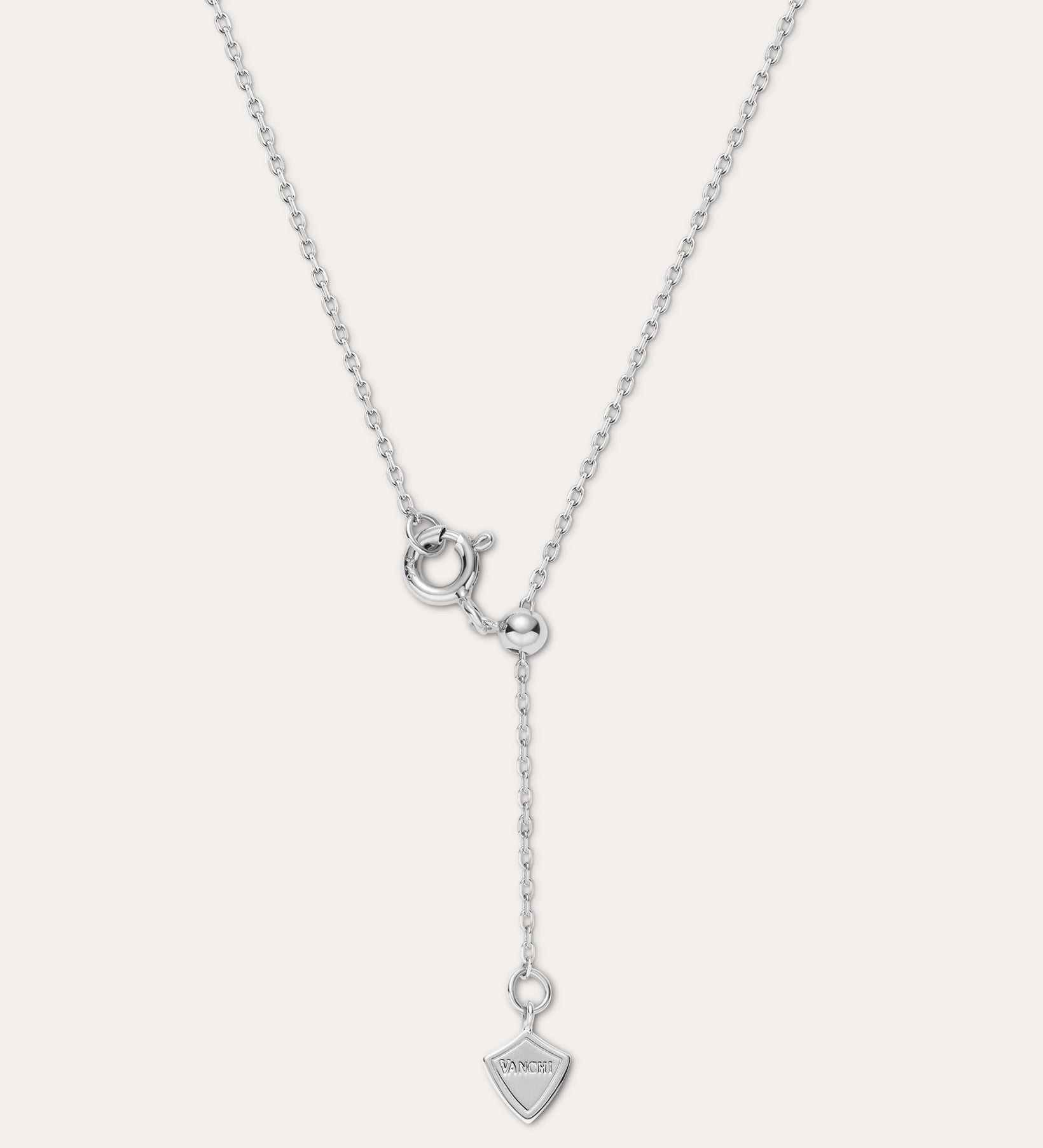 The Mabel Sculptural Droplet Pendant Necklace in Silver features an adjustable chain, a sculptural droplet-shaped pendant, and a simple spring ring clasp with an extended drop chain detail.