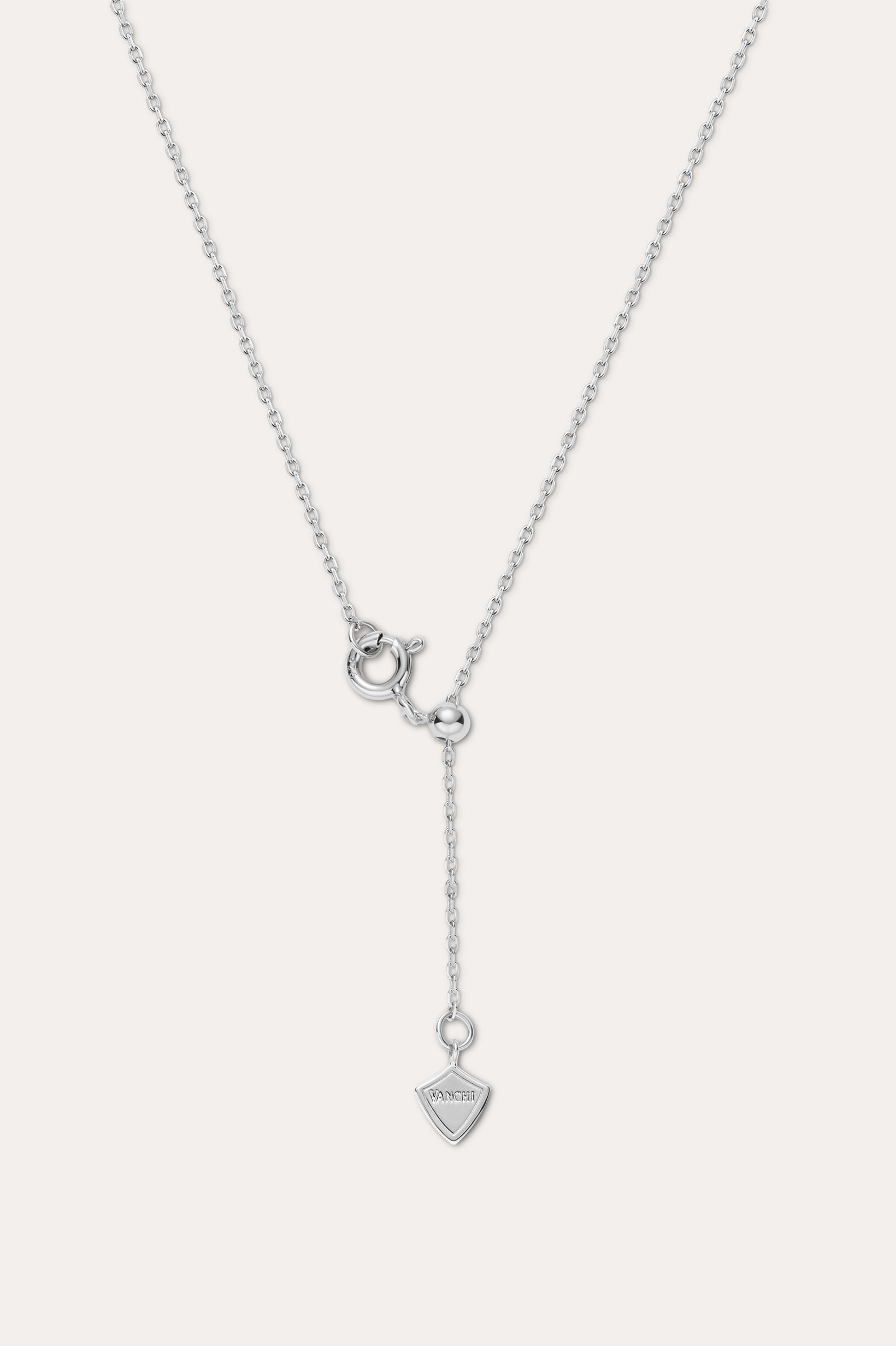 The Mabel Sculptural Droplet Pendant Necklace in Silver features an adjustable chain, a sculptural droplet-shaped pendant, and a simple spring ring clasp with an extended drop chain detail.