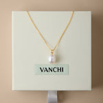 A Freshwater Pearl Necklace in Silver is displayed on a cream-colored VANCHI box, set against a beige background. The elegant design features an adjustable slider chain for the perfect fit.