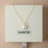 A Freshwater Pearl Necklace in Silver is displayed on a cream-colored VANCHI box, set against a beige background. The elegant design features an adjustable slider chain for the perfect fit.
