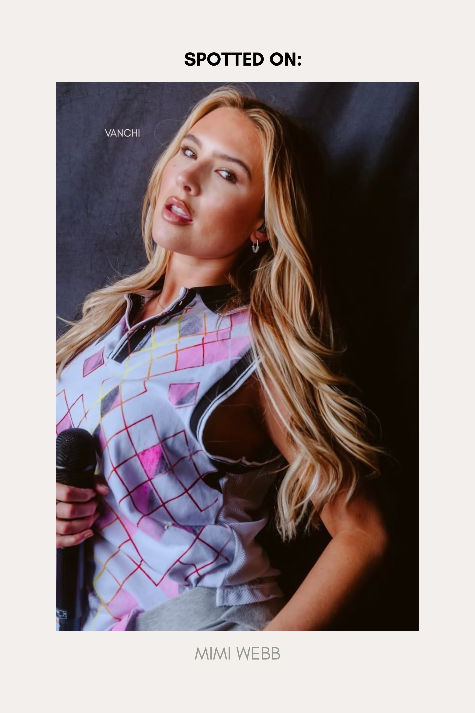 A woman with long blonde hair holds a microphone, wearing a colorful sleeveless top with a grid pattern and the elegant Nouf Pavé Hoop Earrings in Gold, crafted from 18k gold plated metal and sparkling cubic zirconia. The background is plain, with text above her reading “SPOTTED ON:” and below, “MIMI WEBB.”.