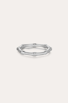 The Bamboo Ring in Silver is a slender band crafted from recycled sterling silver, featuring subtle joint details and showcased on a plain light background.