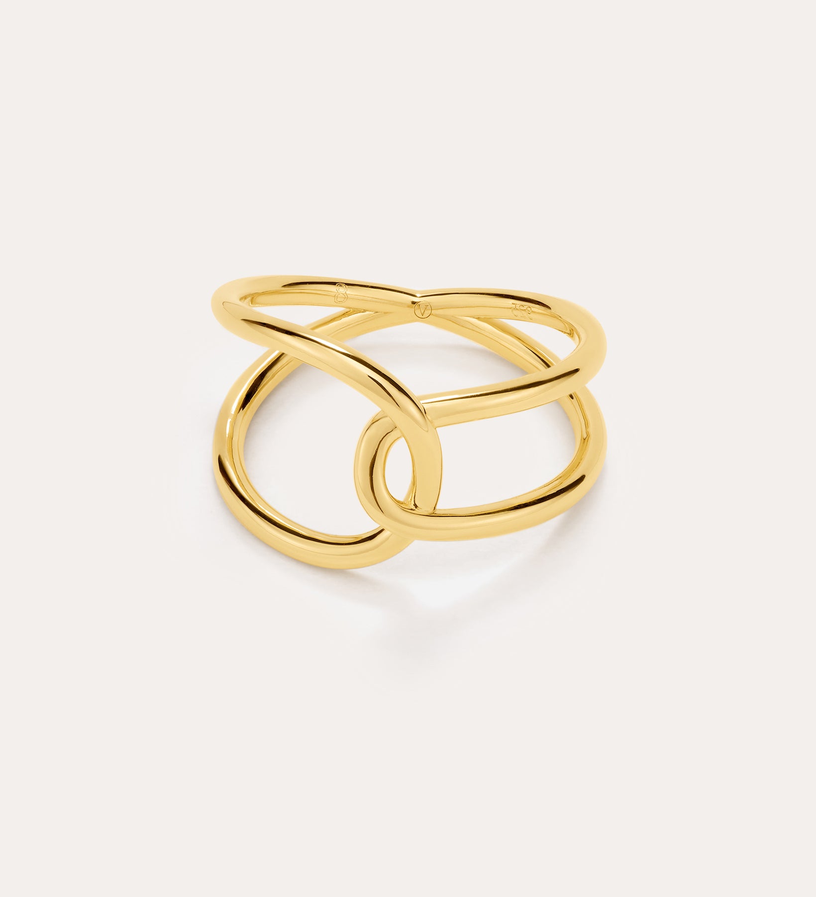 The Ayla Link Ring in Gold features an open, intertwined double-band design for a modern, elegant look, showcased against a plain, light background.