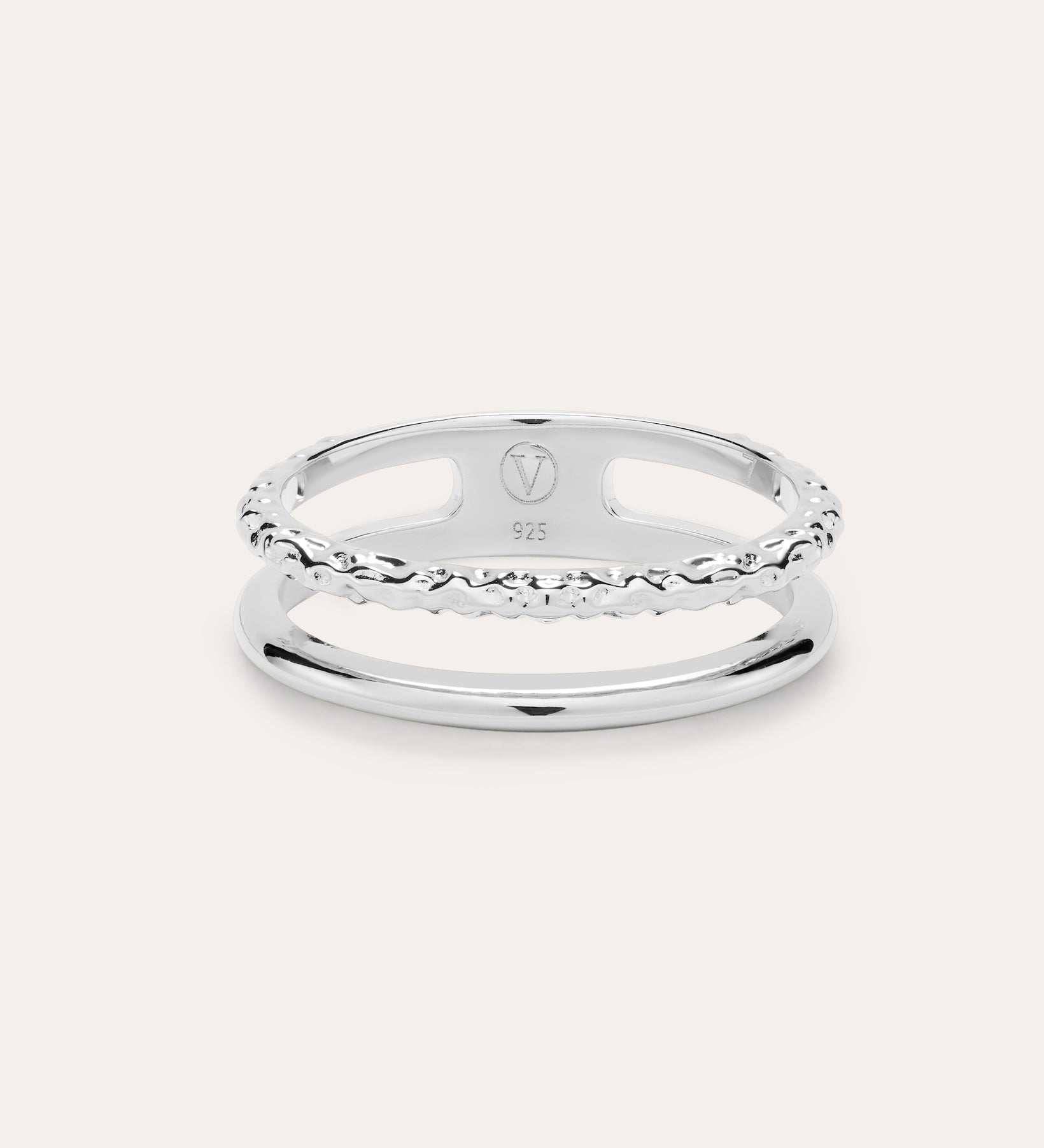 The Molten Double Band Ring in Sterling Silver features two parallel bands—one smooth, one twisted rope—connected at the sides. Stamped 925 and with a geometric logo, it's perfect for everyday wear on a light background.