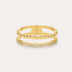 The Molten Crystal Double Band Ring in Gold features 18k gold plating, two connected bands—one with a twisted rope design and the other adorned with cubic zirconia—shown against a light background.