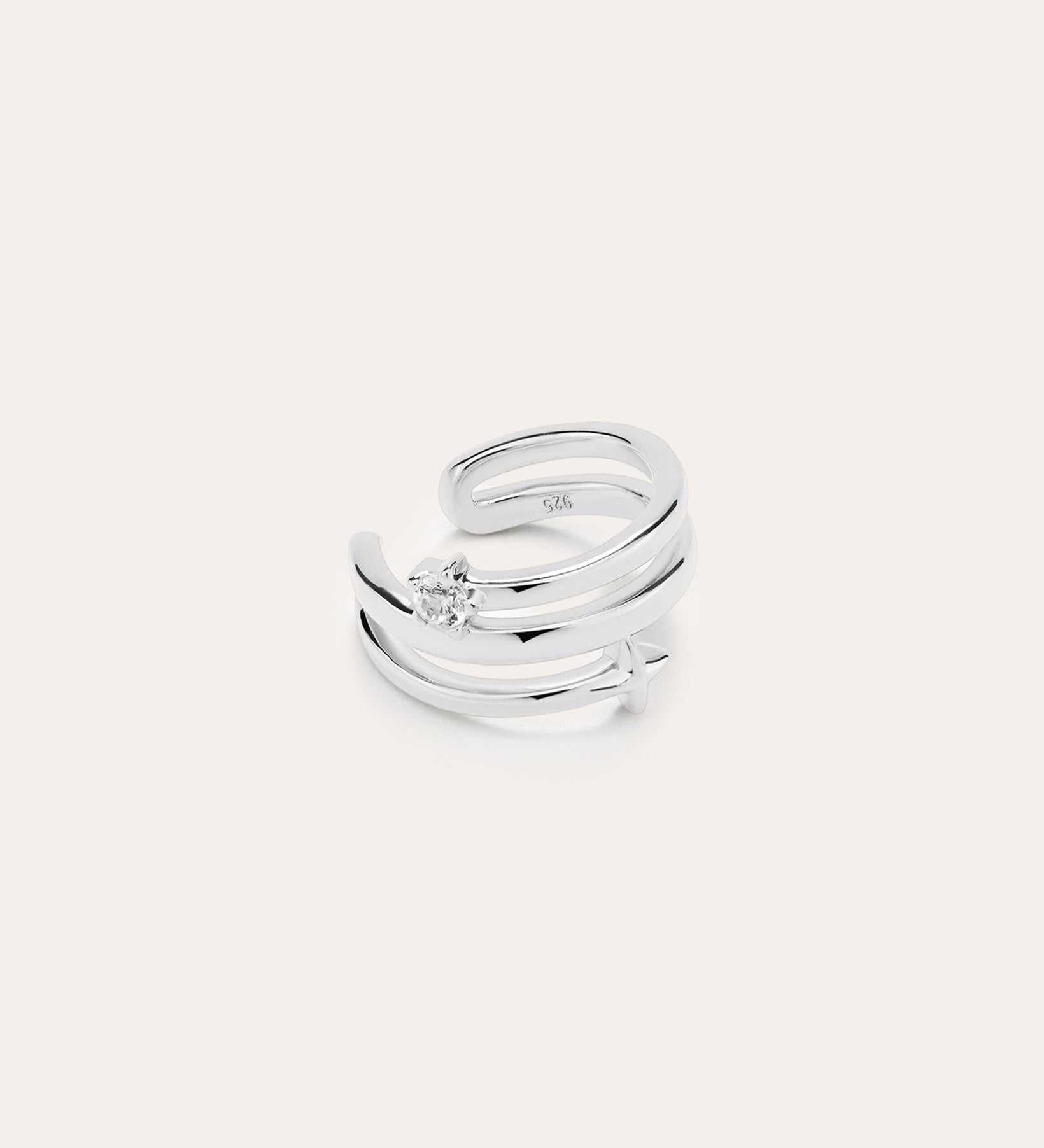 The Star Crystal Ear Cuff in sterling silver features a modern, double-band design with a single round gemstone, inspired by celestial jewelry, displayed against a plain white background.