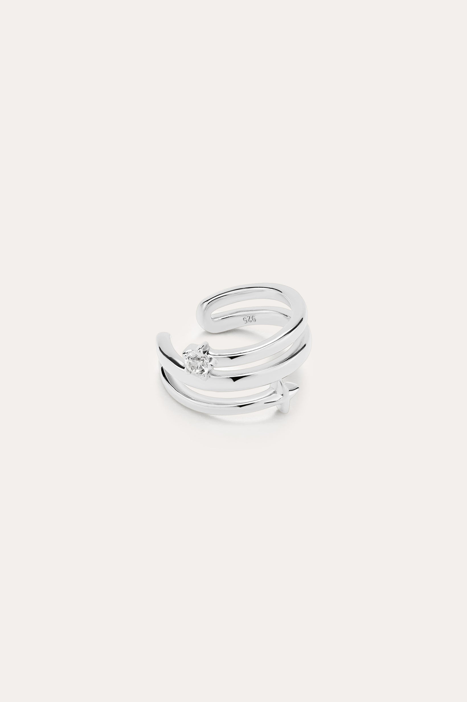 The Star Crystal Ear Cuff in sterling silver features a modern, double-band design with a single round gemstone, inspired by celestial jewelry, displayed against a plain white background.