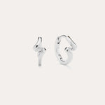 A pair of Ribbon Twist Huggies in sterling silver—one shaped like a lightning bolt, the other with a smooth, twisted ribbon design—are displayed against a plain white background.