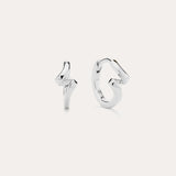 A pair of Ribbon Twist Huggies in sterling silver—one shaped like a lightning bolt, the other with a smooth, twisted ribbon design—are displayed against a plain white background.