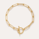 The Paperclip Toggle Bracelet in Gold, crafted in 18k gold plated finish with elongated oval links and a twisted toggle clasp, is shown against a plain light background.