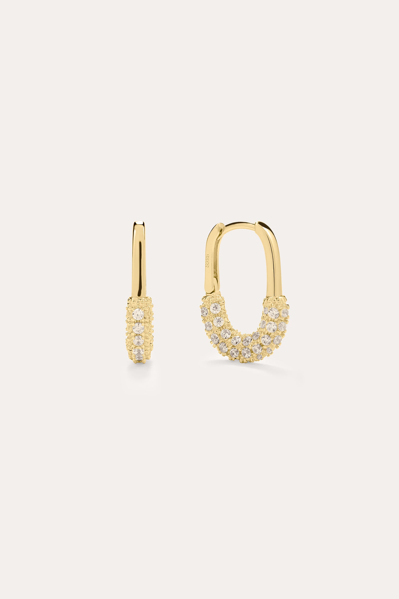 The Nouf Pavé Hoop Earrings in 18k Gold Plated feature small hoops encrusted with sparkling cubic zirconia along the lower half, shown on a plain light background.