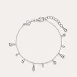 The Rhea Molten Cascade Bracelet in Silver features delicate rhodium-plated teardrop charms evenly spaced along a slender chain, complete with an adjustable clasp and extra extension links—ideal as a dainty stand-alone piece or layered for a chic, stacked style.