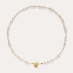 The Flora Multi Pearl Toggle Choker in Gold features irregularly shaped white freshwater pearls and a small 14K gold plated butterfly charm at the center, finished with a floral toggle clasp and displayed on a plain white background.