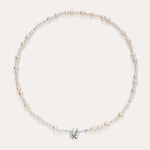 The Flora Multi Pearl Toggle Choker in Sterling Silver is a delicate piece featuring irregularly shaped freshwater pearls and a small sterling silver bow charm at the center, elegantly displayed on a plain light background.