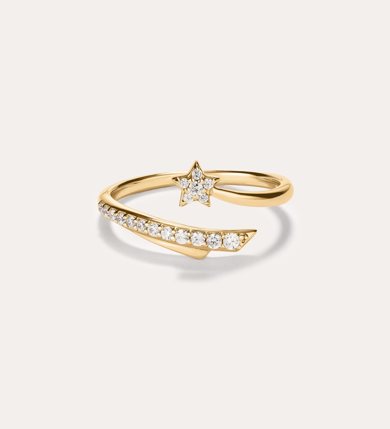 The Crystal Shooting Star Open Ring in Gold features a star-shaped design adorned with small white gemstones on both the band and the star, crafted in 14K gold plated finish. Set against a plain light background, this adjustable ring offers a comfortable fit.