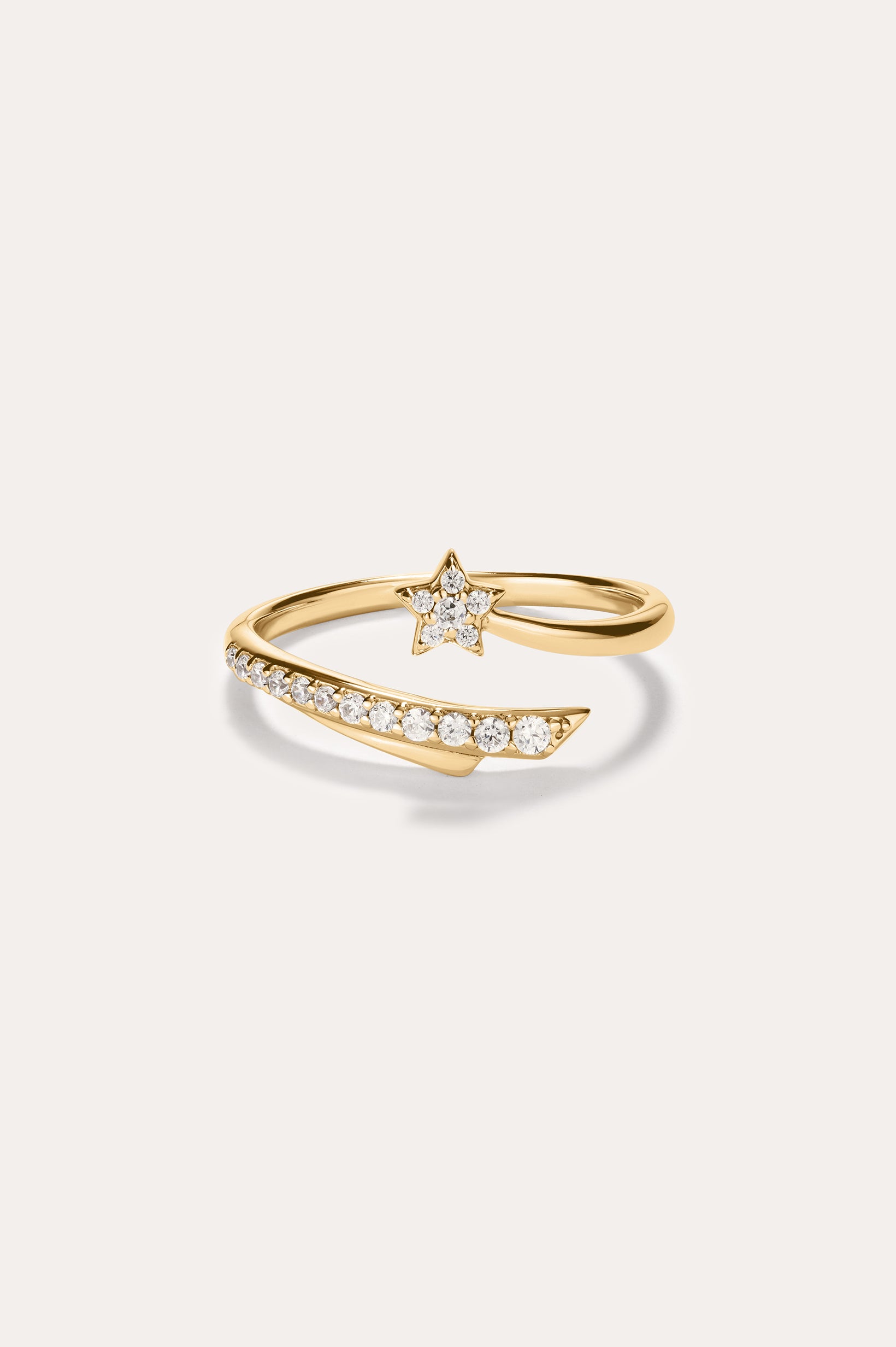 The Crystal Shooting Star Open Ring in Gold features a star-shaped design adorned with small white gemstones on both the band and the star, crafted in 14K gold plated finish. Set against a plain light background, this adjustable ring offers a comfortable fit.