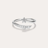 Introducing the Crystal Shooting Star Open Ring in Silver—a sterling silver adjustable ring with a wraparound design, showcasing a small star embellished with clear gemstones and a partially encrusted band of sparkling stones, evoking the delicate beauty of a crystal shooting star.
