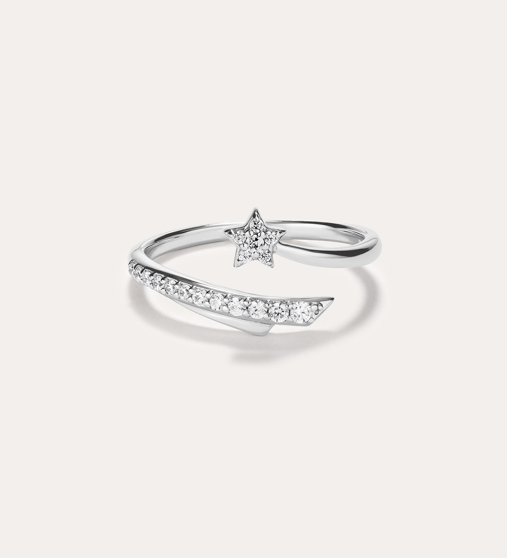 Introducing the Crystal Shooting Star Open Ring in Silver—a sterling silver adjustable ring with a wraparound design, showcasing a small star embellished with clear gemstones and a partially encrusted band of sparkling stones, evoking the delicate beauty of a crystal shooting star.