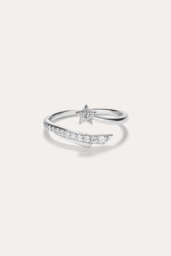 Introducing the Crystal Shooting Star Open Ring in Silver—a sterling silver adjustable ring with a wraparound design, showcasing a small star embellished with clear gemstones and a partially encrusted band of sparkling stones, evoking the delicate beauty of a crystal shooting star.