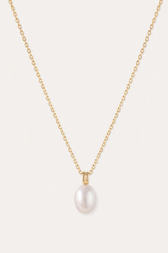 A 14K gold plated chain necklace, featuring a single round white freshwater pearl pendant at its center, is displayed on a plain light background. The Freshwater Pearl Necklace in Gold includes an adjustable slider chain for a perfect fit with any neckline.