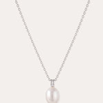 Introducing the Freshwater Pearl Necklace in Silver—a striking jewelry piece showcasing a single round white pearl pendant, elegantly suspended from a sterling silver adjustable slider chain and set against a plain light background.