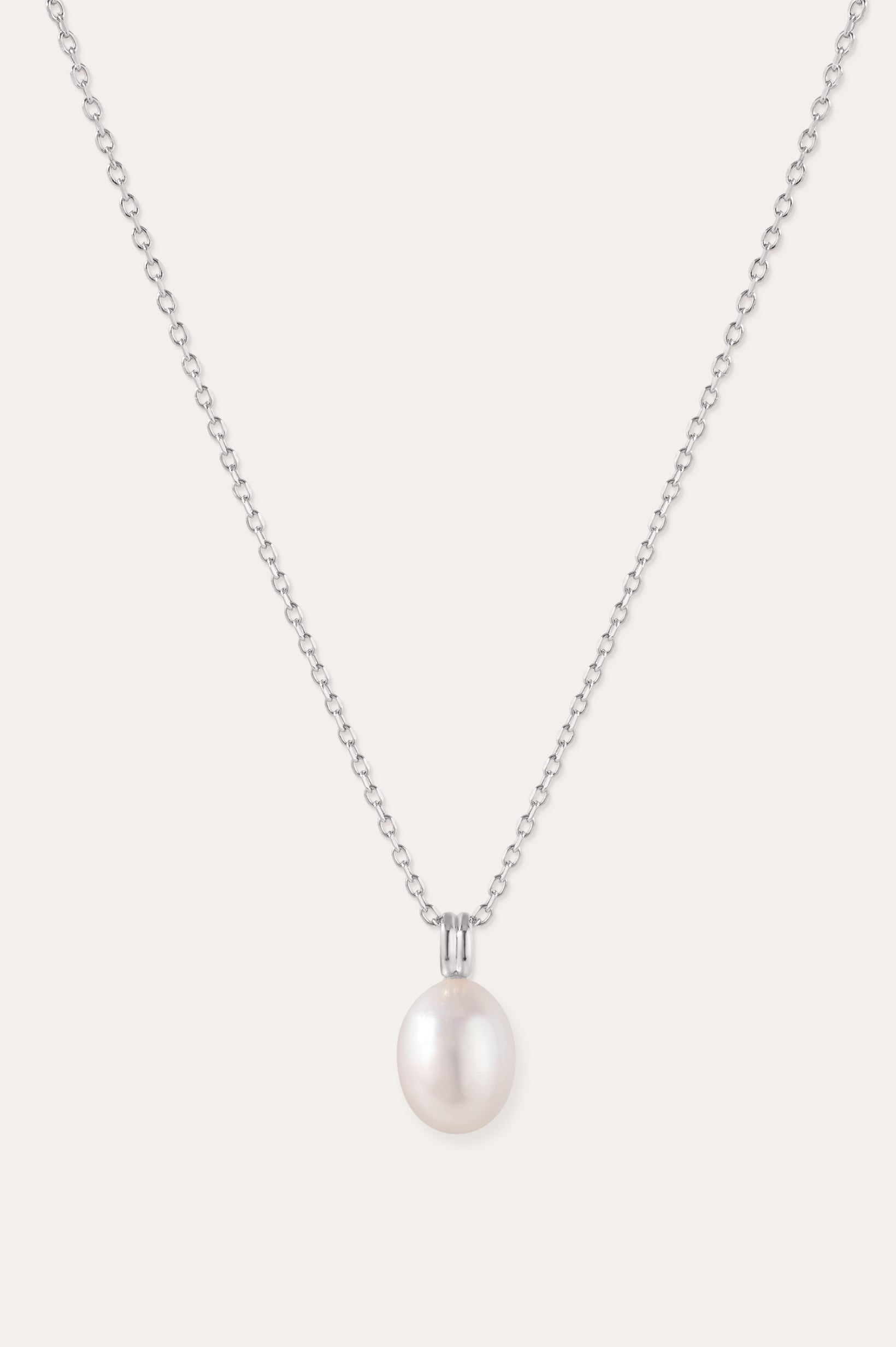Introducing the Freshwater Pearl Necklace in Silver—a striking jewelry piece showcasing a single round white pearl pendant, elegantly suspended from a sterling silver adjustable slider chain and set against a plain light background.