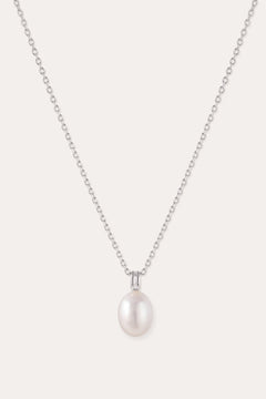 Introducing the Freshwater Pearl Necklace in Silver—a striking jewelry piece showcasing a single round white pearl pendant, elegantly suspended from a sterling silver adjustable slider chain and set against a plain light background.