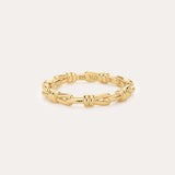 The Noa Link Ring in Gold features 14K gold plating and delicate knot details, with a 925 stamp on the inside. Set against a plain light background, it’s perfect for stacking and elevating your everyday style.