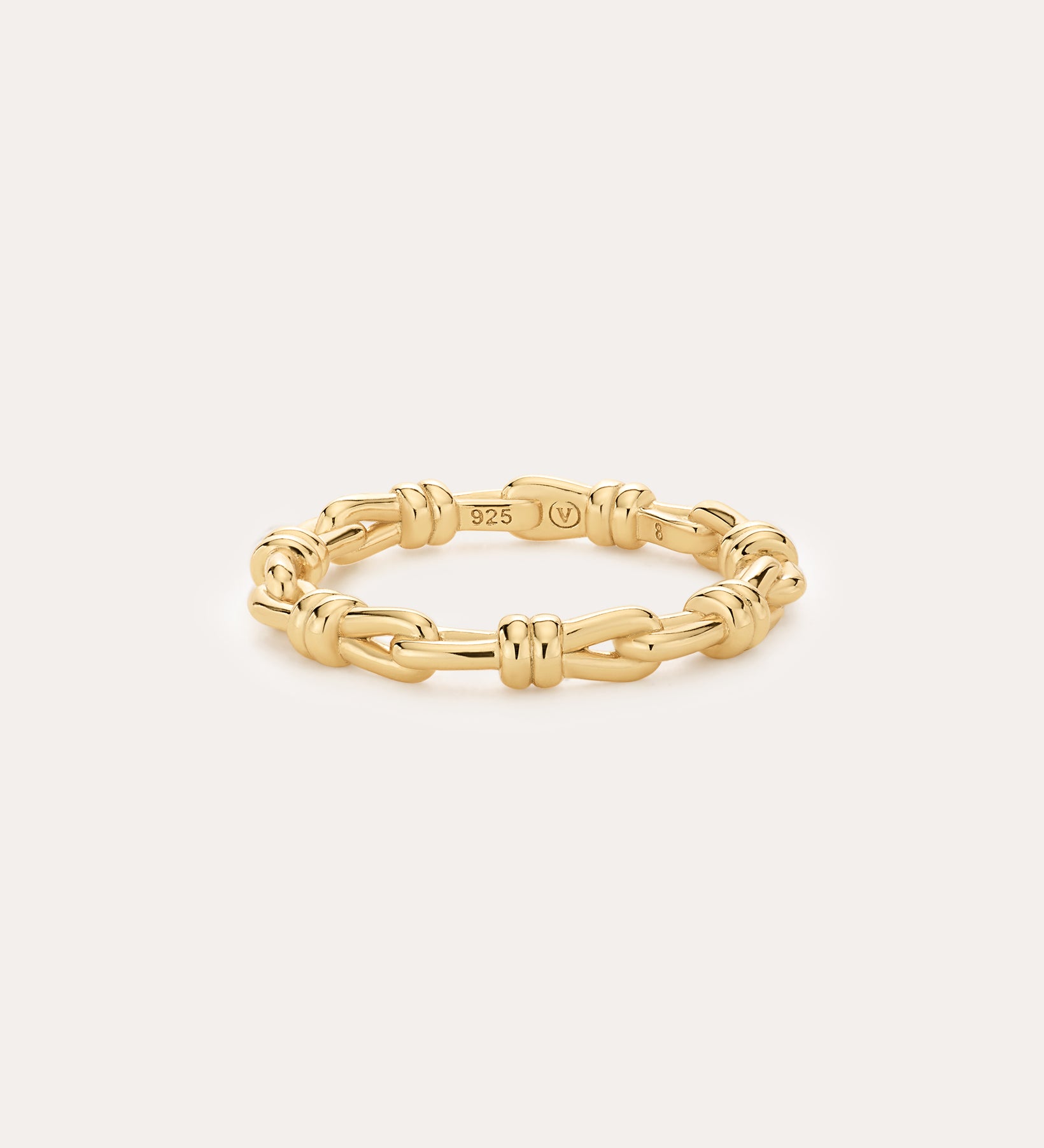The Noa Link Ring in Gold features 14K gold plating and delicate knot details, with a 925 stamp on the inside. Set against a plain light background, it’s perfect for stacking and elevating your everyday style.