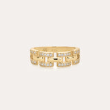 The Crystal Link Ring in Gold features a 14K gold plated, geometric chain link design with small embedded clear stones, and is displayed on a plain light background.