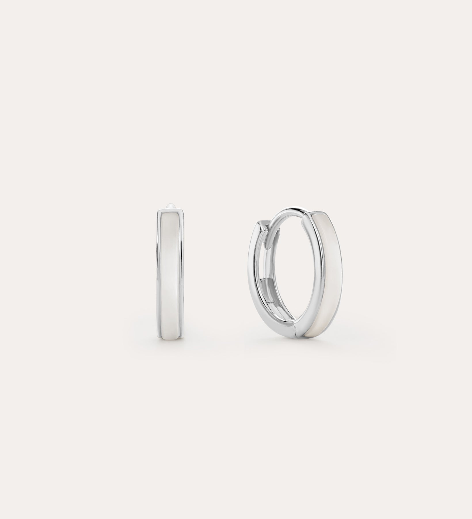 The Mother of Pearl Huggies in Sterling Silver are shown against a white background, with one earring front-facing and the other from the side—lightweight hoops ideal for daily wear or stacking with your favourite jewellery.
