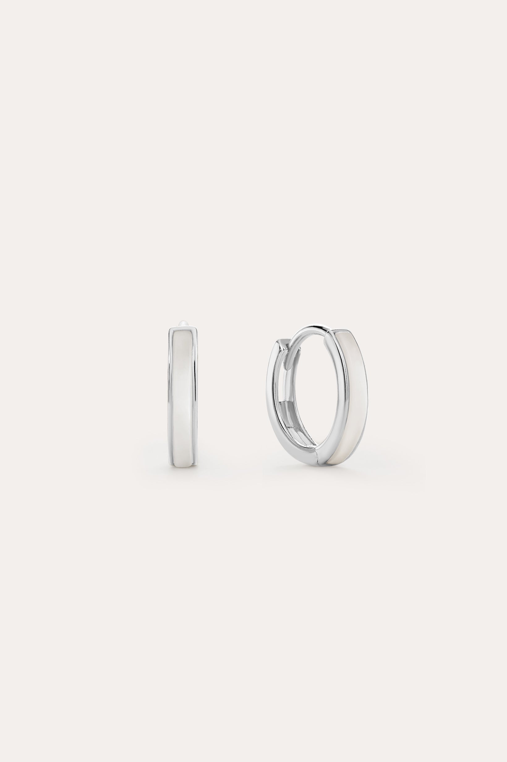 The Mother of Pearl Huggies in Sterling Silver are shown against a white background, with one earring front-facing and the other from the side—lightweight hoops ideal for daily wear or stacking with your favourite jewellery.