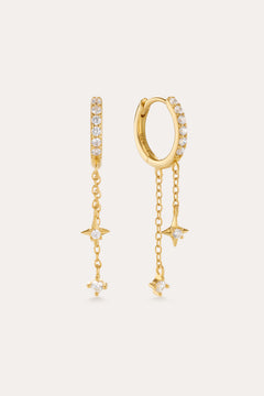 The Star Double Chain Dangle Huggies in Gold feature 18k gold plating with two star-shaped charms on each chain drop and sparkling cubic zirconia for an elegant, delicate look.