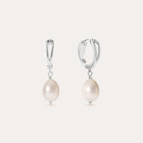 A pair of Freshwater Pearl Charm Huggies in Sterling Silver, each adorned with a single round white freshwater pearl, displayed on a plain light background—these earrings are the perfect everyday essential.