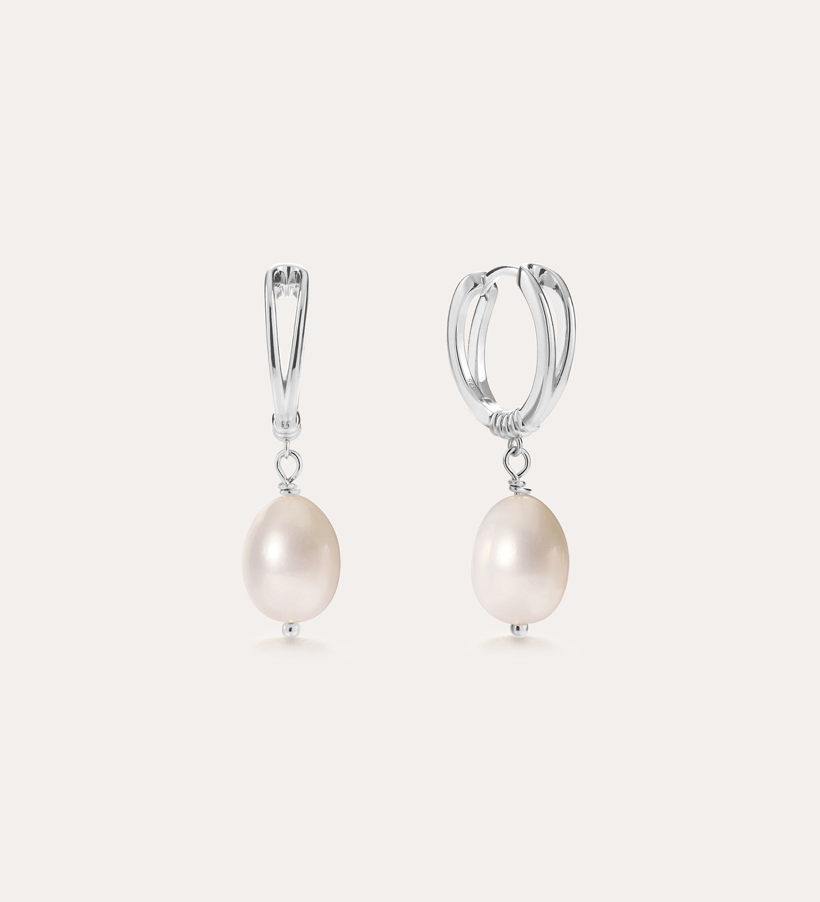 A pair of Freshwater Pearl Charm Hoops in Sterling Silver, each adorned with a single round white freshwater pearl suspended from the bottom, displayed on a plain light background.
