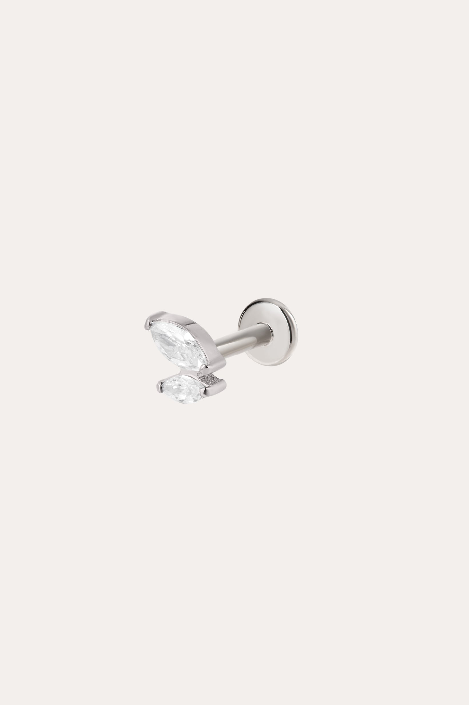 A platinum Double Marquise Threadless Flat Back Titanium Cartilage Stud earring, featuring a clear marquise-cut gemstone in a minimalist prong setting, is displayed against a plain white background. This hypoallergenic cartilage jewelry showcases a comfortable and secure titanium flat back design with a Platinum PVD finish.