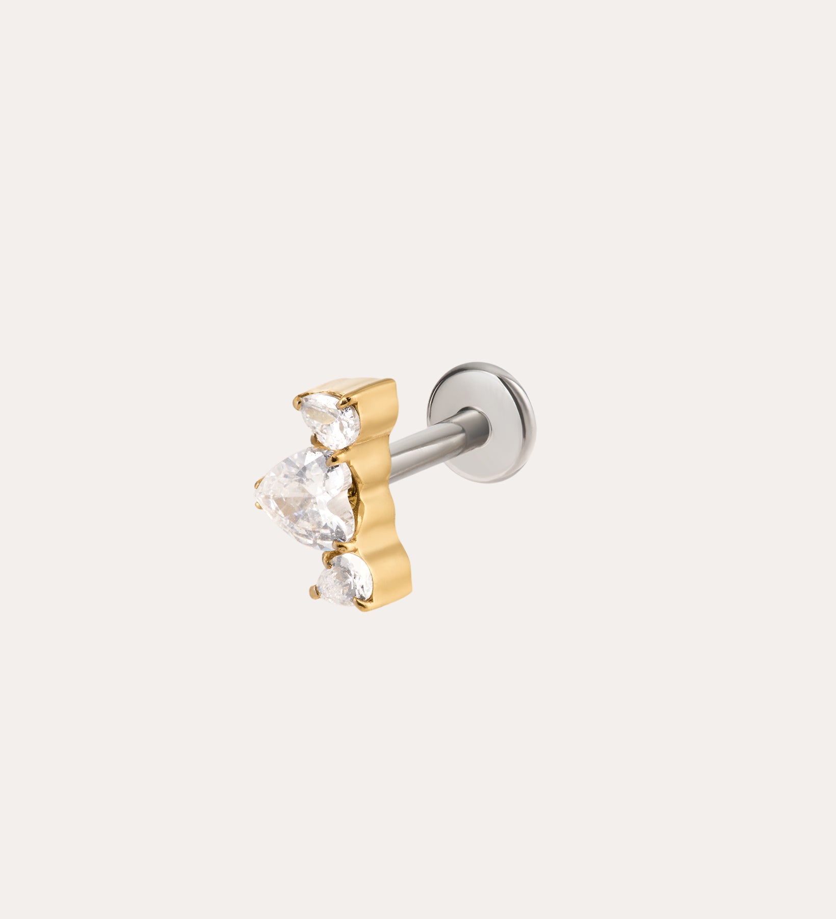 A Curved Crystal Threadless Flat Back Titanium Cartilage Stud in Yellow Gold PVD, featuring a central teardrop-shaped clear gemstone flanked by two smaller pear-shaped clear crystals, displayed on a plain light background.