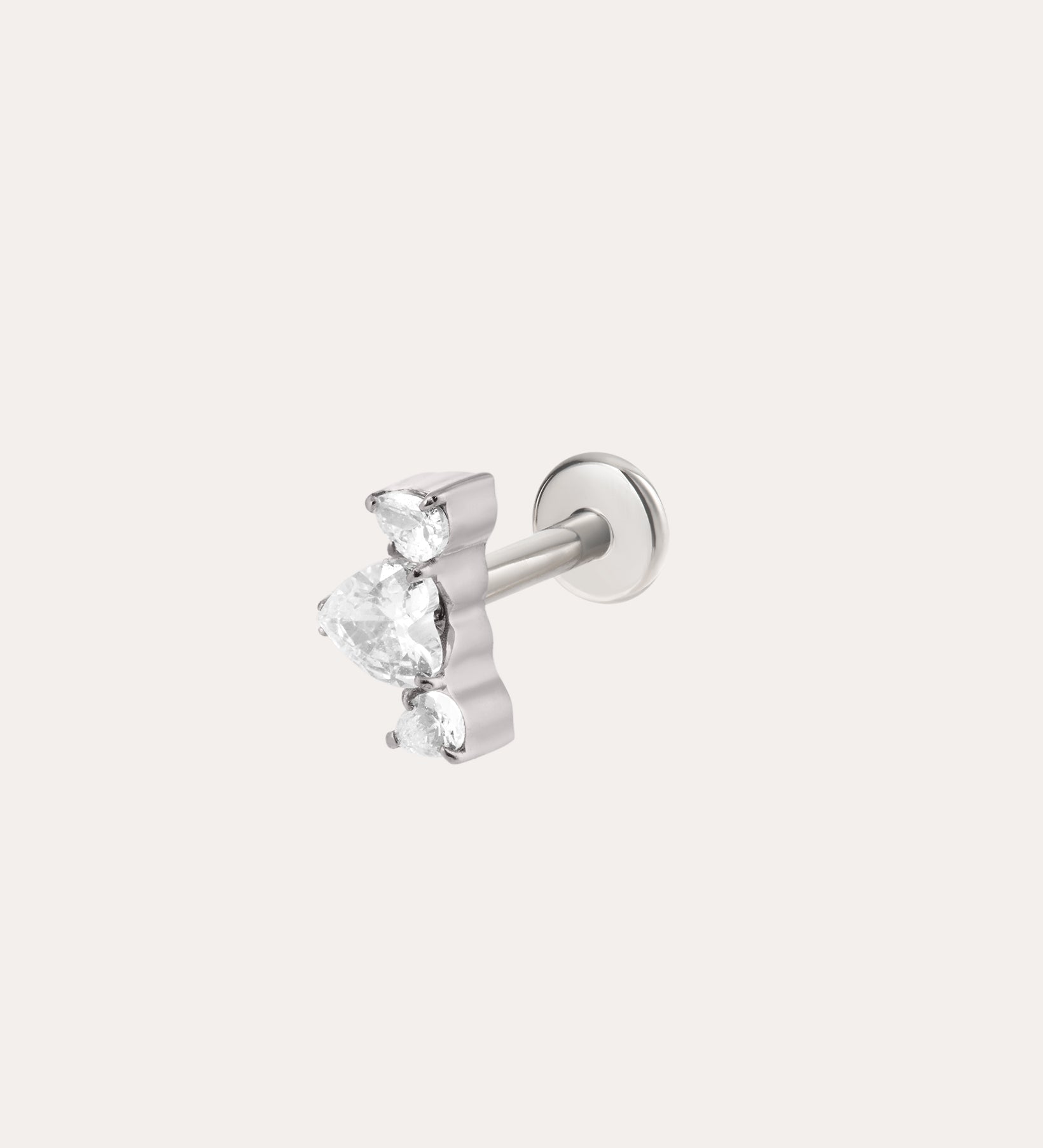 The Curved Crystal Threadless Flat Back Titanium Cartilage Stud in Platinum features a cluster of three clear, teardrop-shaped gemstones arranged in a fan shape against a plain light background. This earring is hypoallergenic and comes with a comfortable titanium flat back in platinum PVD, making it ideal for sensitive ears.