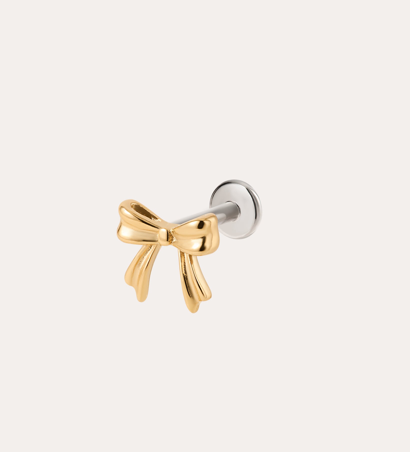 A Bow Threadless Flat Back Titanium Cartilage Stud in Gold, featuring a yellow gold PVD bow design with a titanium flat back and silver backing, ideal for use as a bow cartilage stud or gold ear piercing, displayed against a plain white background.