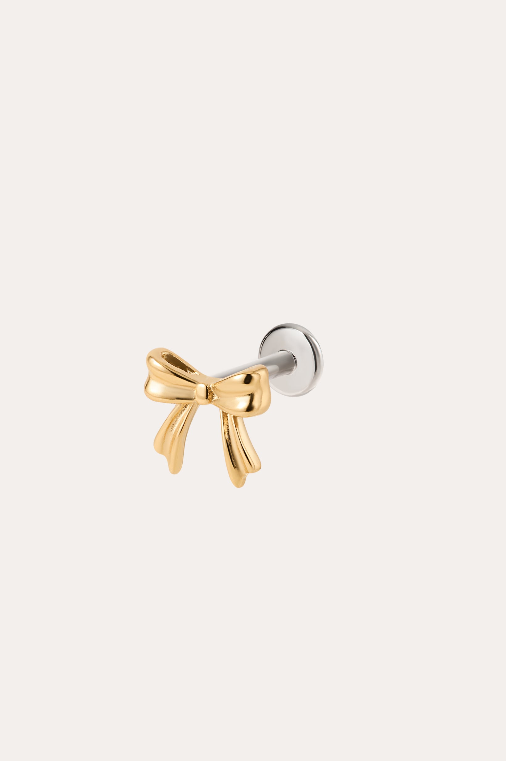 A Bow Threadless Flat Back Titanium Cartilage Stud in Gold, featuring a yellow gold PVD bow design with a titanium flat back and silver backing, ideal for use as a bow cartilage stud or gold ear piercing, displayed against a plain white background.