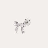 A Bow Threadless Flat Back Titanium Cartilage Stud in a Platinum PVD finish, crafted as a hypoallergenic ear piercing, is displayed against a plain, light background.