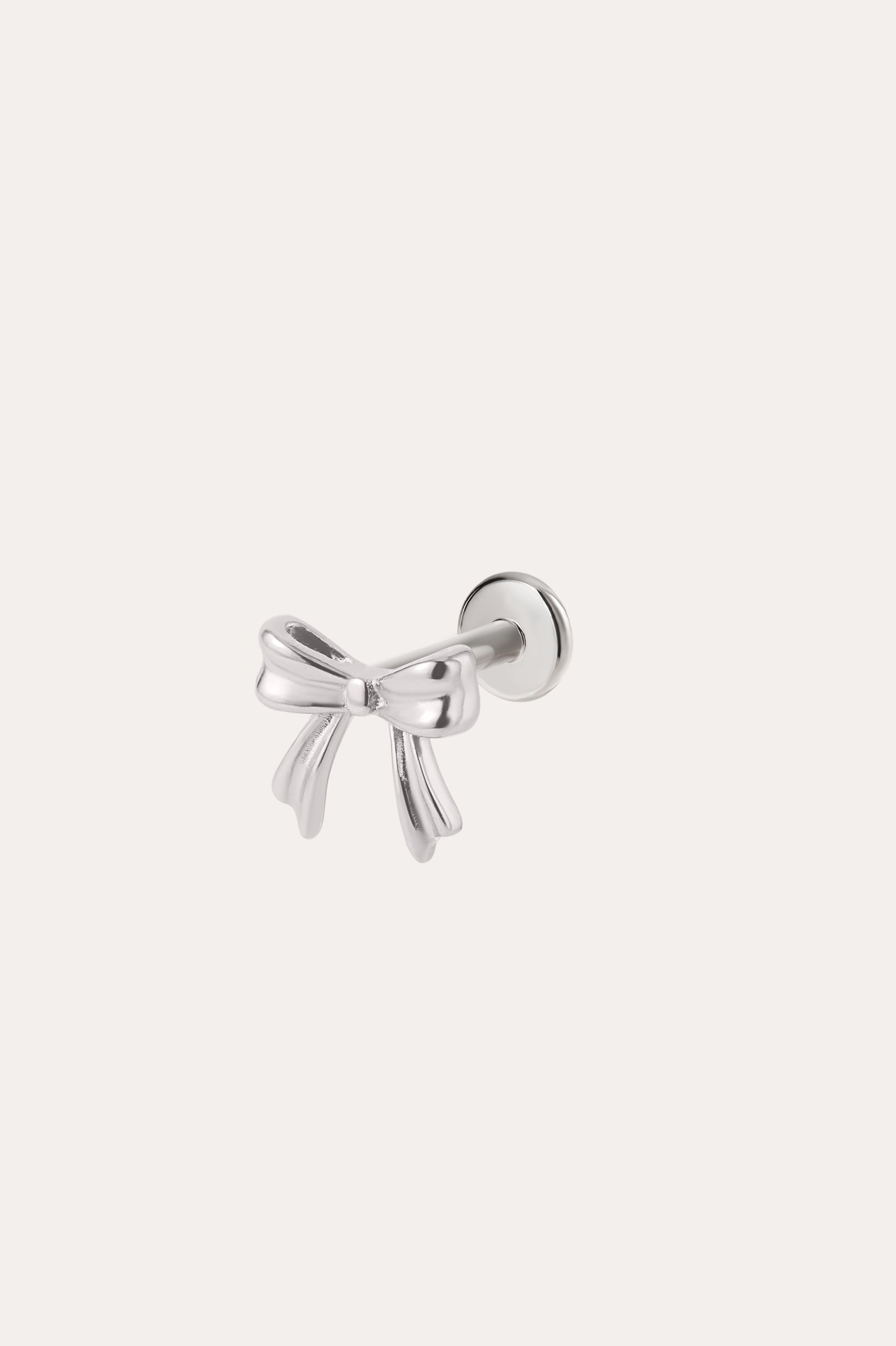 A Bow Threadless Flat Back Titanium Cartilage Stud in a Platinum PVD finish, crafted as a hypoallergenic ear piercing, is displayed against a plain, light background.