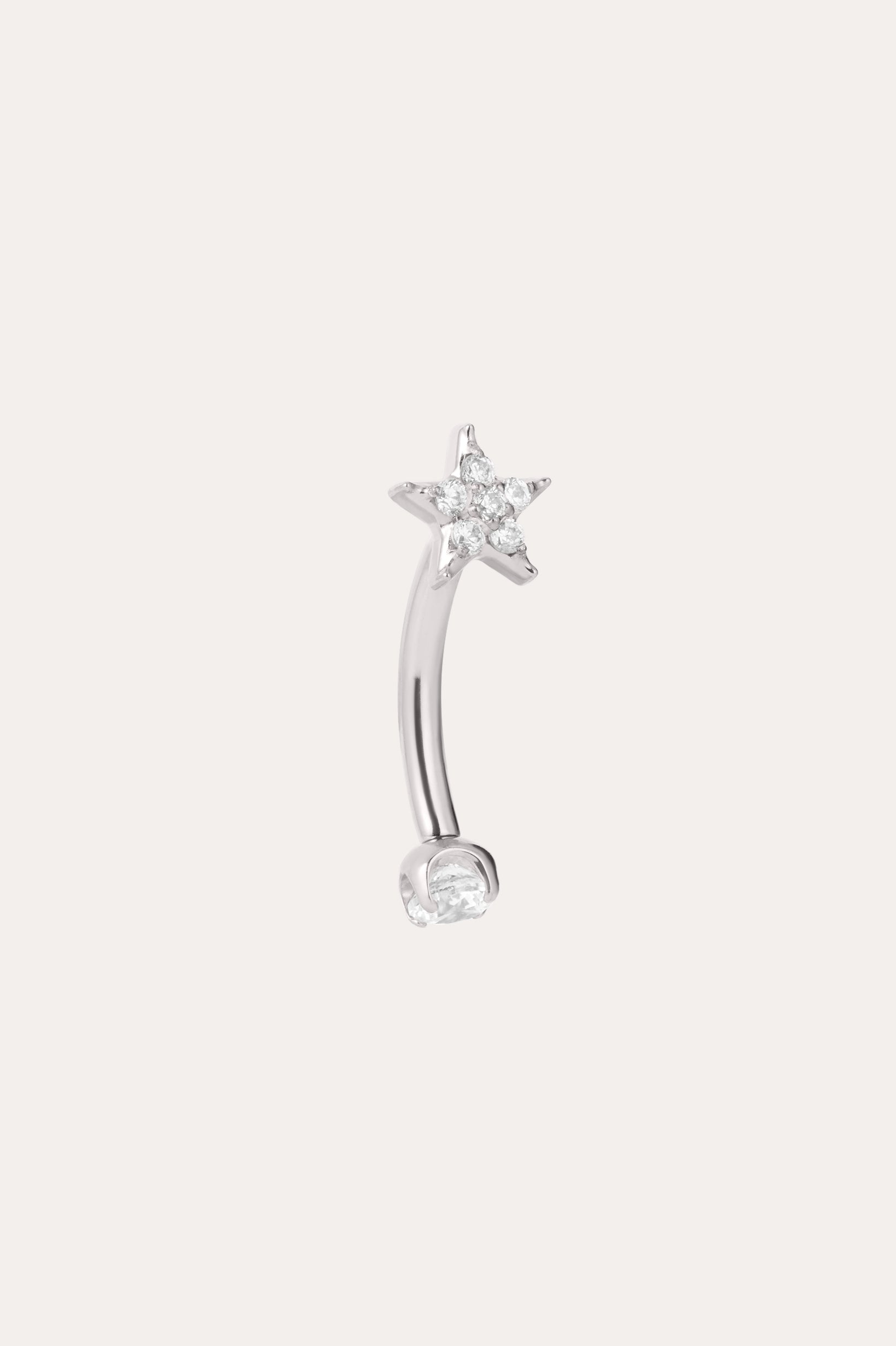 A curved implant-grade titanium barbell earring in a platinum PVD finish, featuring a small clear gemstone at one end and a star-shaped design with sparkling clear stones at the other, set against a plain light background. This hypoallergenic Crystal Star Titanium Rook Barbell in Platinum offers elegant sparkle and comfortable wear for sensitive ears.