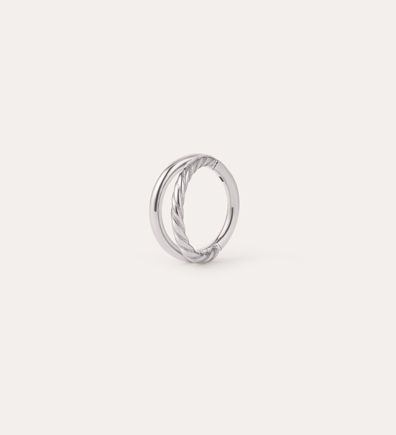 A platinum-toned circular earring, the Double Clicker Titanium Ring in Platinum, features a twisted rope design on one side and is crafted from hypoallergenic titanium, shown against a plain white background.