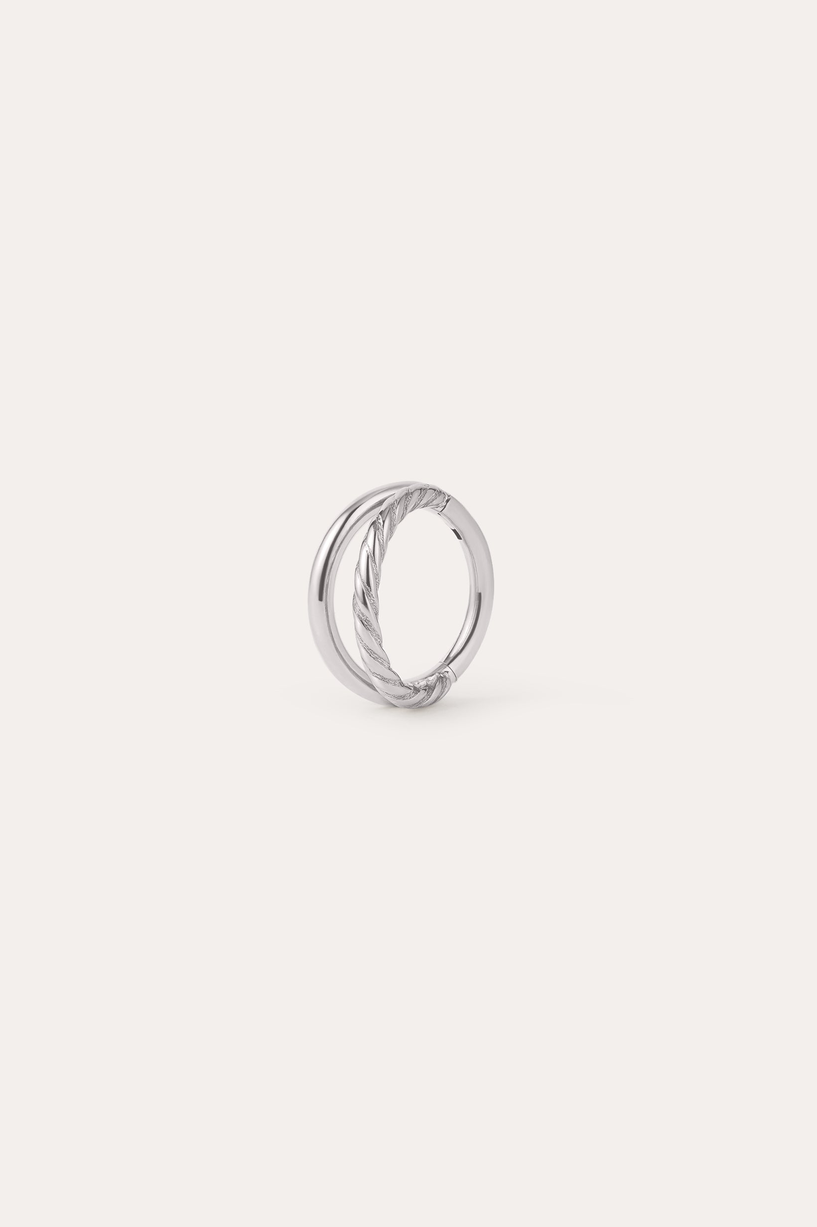 A platinum-toned circular earring, the Double Clicker Titanium Ring in Platinum, features a twisted rope design on one side and is crafted from hypoallergenic titanium, shown against a plain white background.